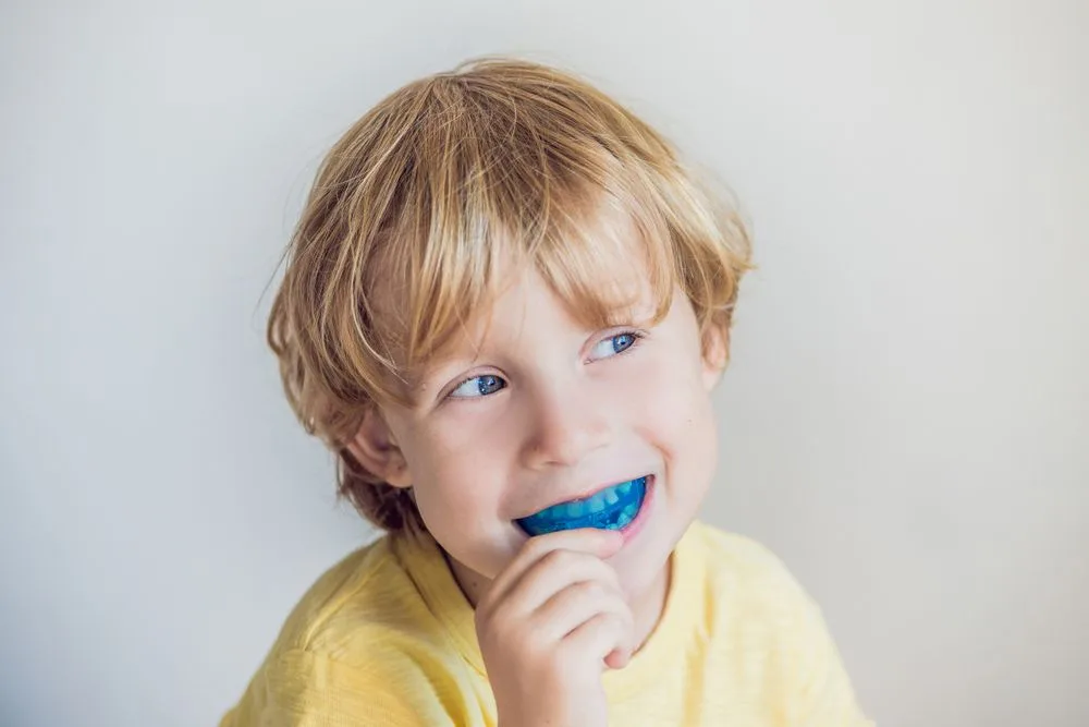 Three-year-old boy showing a myofunctional trainer — dental clinic in Buderim, QLD