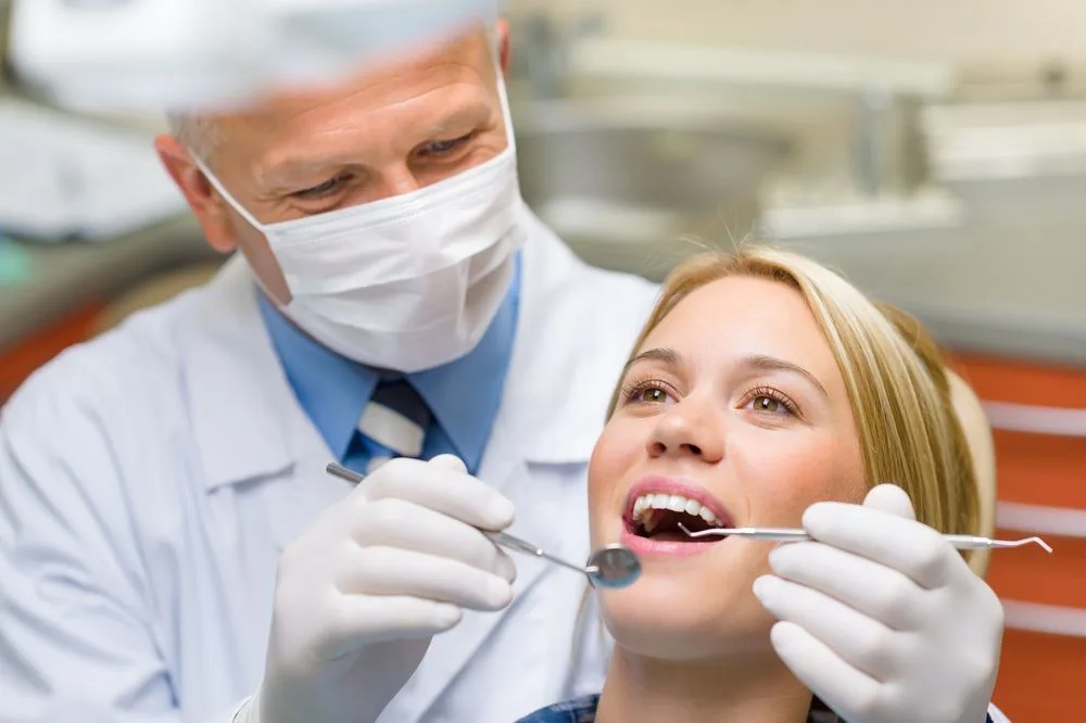 Dentist checking a patient's teeth for caries prevention — dental clinic in Maroochydore, QLD