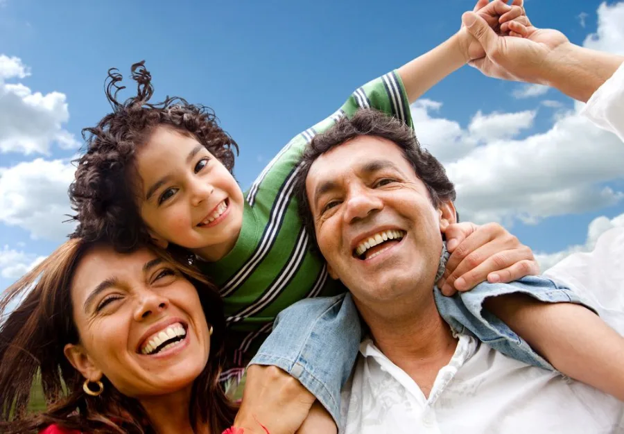 Smiling family of three outdoors — patients of our dental clinic in Buderim, QLD