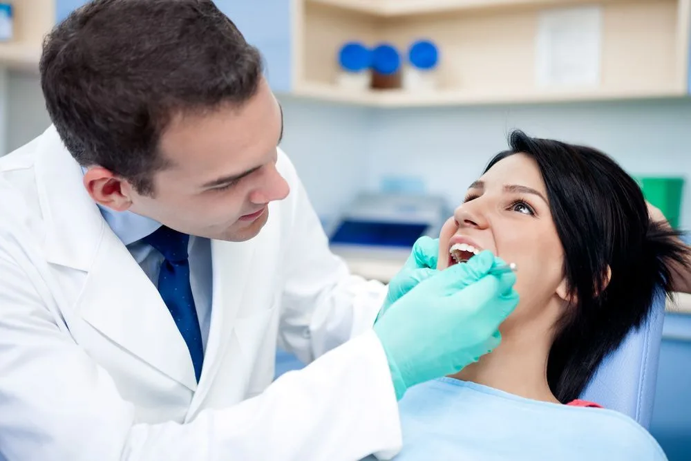 Dentist treating a patient in the treatment chair — dental clinic in Buderim, QLD