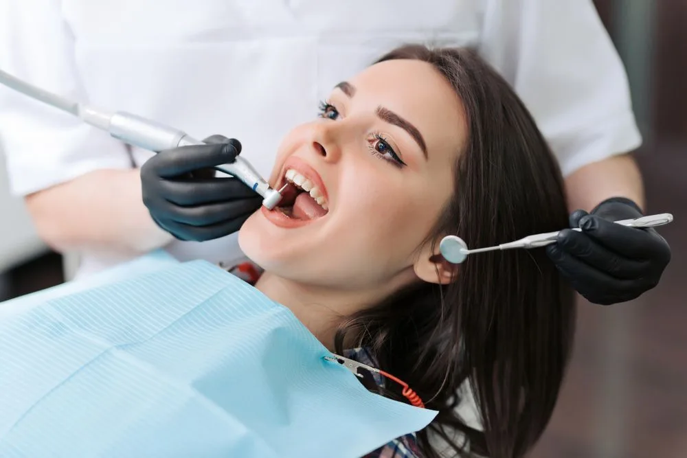 Close-up of a dentist performing a teeth cleaning procedure — dental clinic in Buderim, QLD